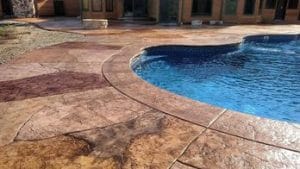Durable and stylish concrete pool deck patio, designed for both aesthetics and functionality around the pool area.