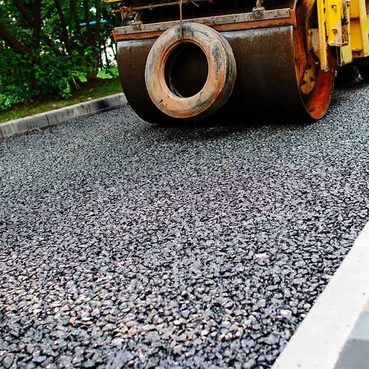 resurfacing Side-by-side comparison of a driveway before and after sealcoating. The 'before' image displays signs of wear, including visible cracks, faded color, and a rough texture. In the 'after' image, the driveway appears refreshed, with a smooth, dark surface, showcasing the positive impact of sealcoating in enhancing the overall appearance and longevity of the driveway.