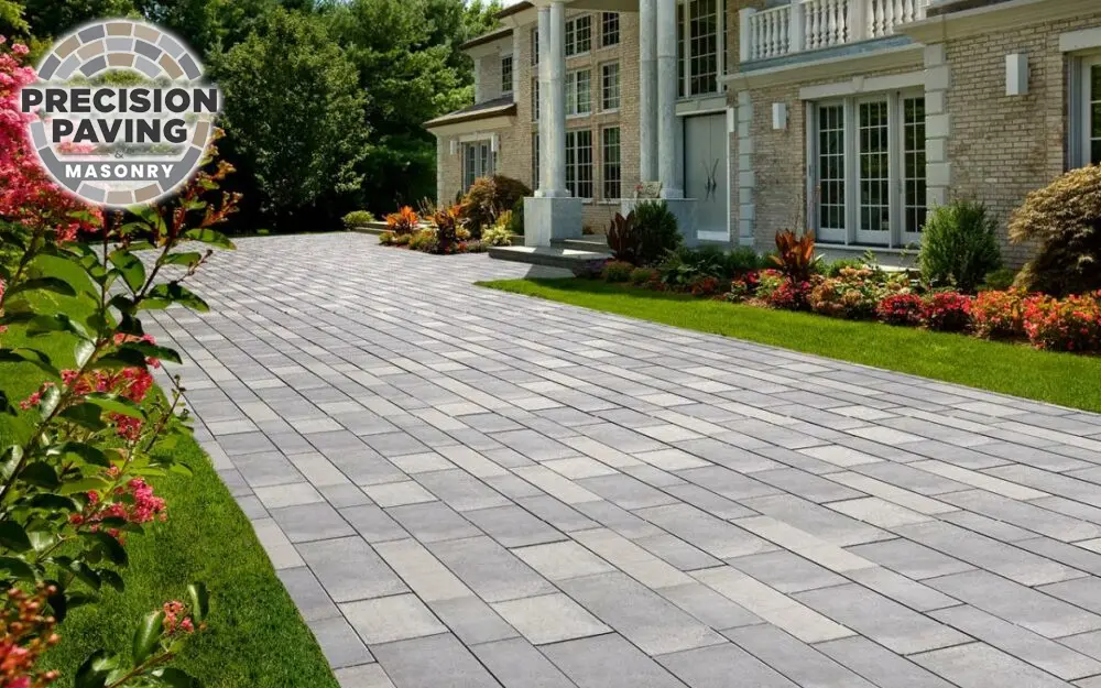 An image showcasing a beautiful paver walkway surrounded by lush greenery, highlighting the benefits of concrete pavers for enhancing outdoor spaces.